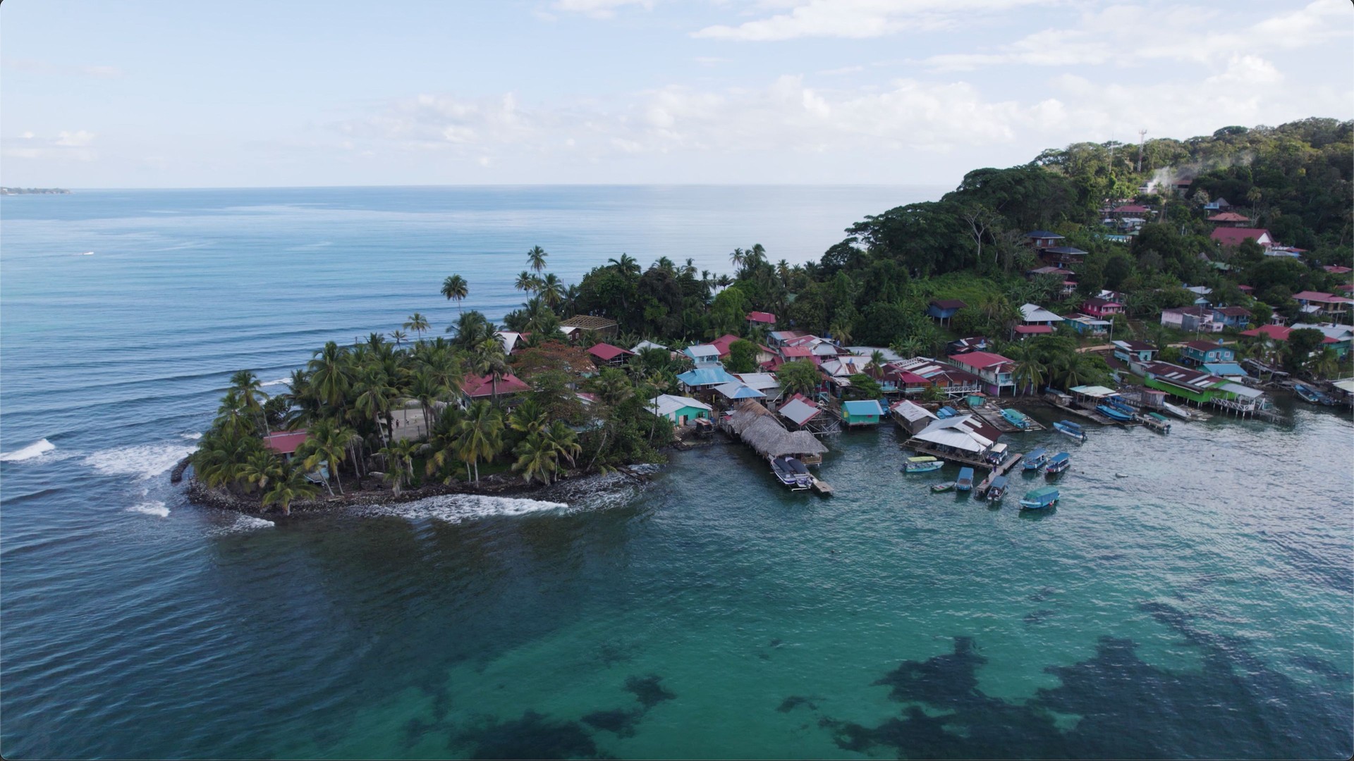 Tropical Island Bastimentos in Panama, caribbean village, houses and moored fishing boats, aerial